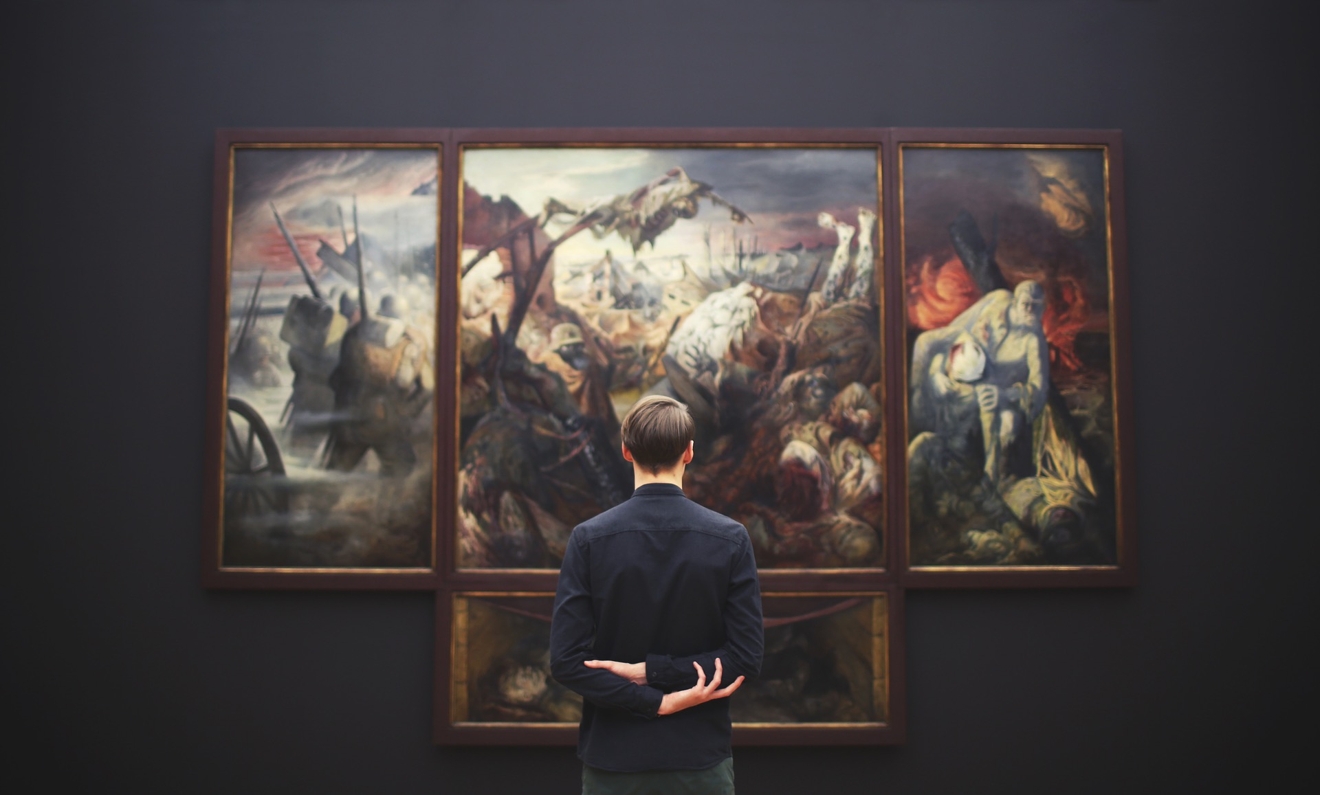 man looking at art